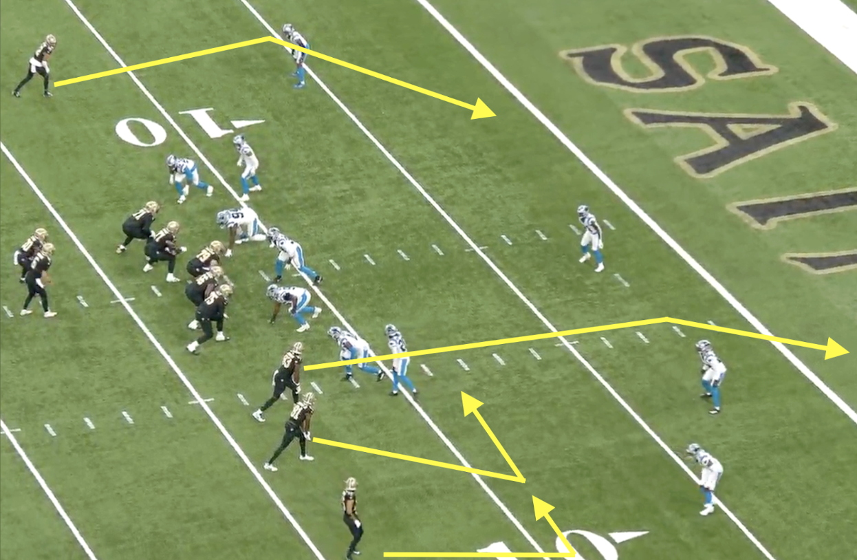 A football play unfolds near the 20-yard line, with yellow arrows highlighting Kellen Moore’s pre-snap formation.