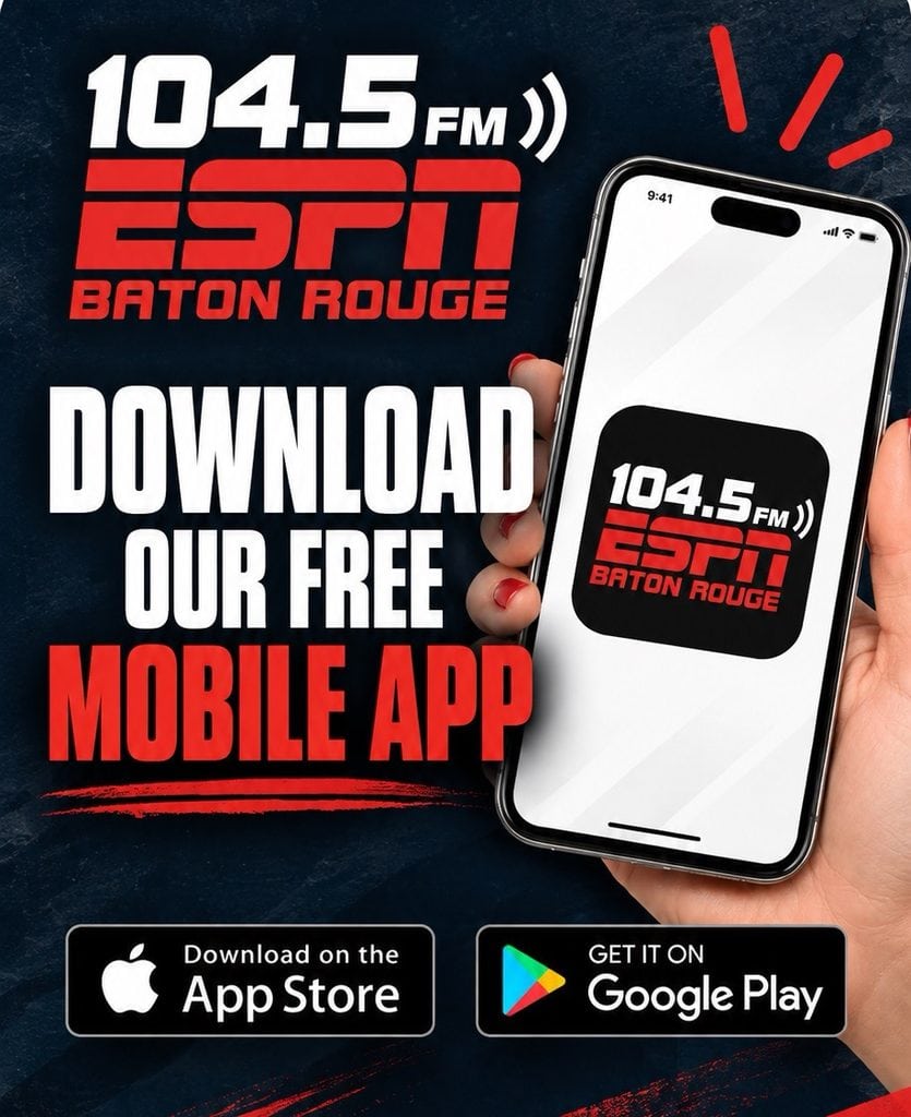 A hand holds a phone showing the 104.5 ESPN Baton Rouge app, promoting free downloads on the App Store and Google Play.