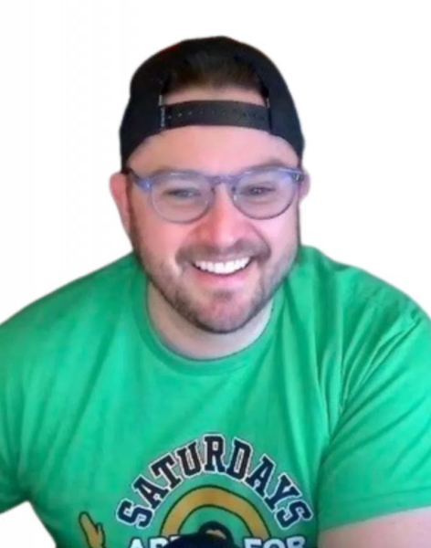 Chris Marler smiles against a white background, wearing glasses, a backwards cap, and a green "Saturdays Are For" shirt.