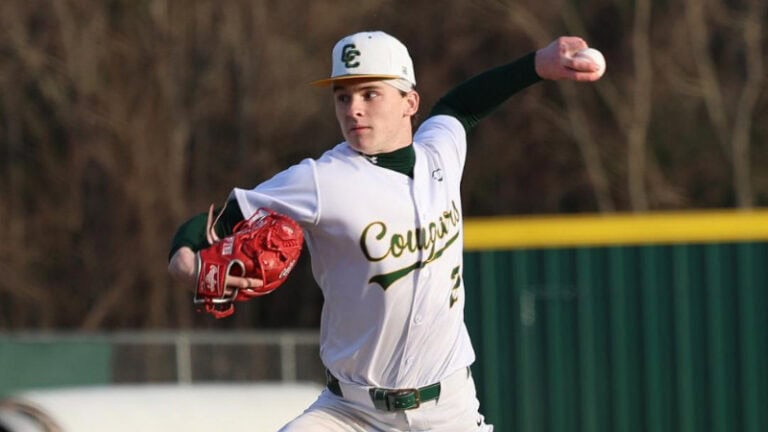 Kade Luker, wearing a white and green uniform and a red glove, pitches on an outdoor field as he aims for 2026 LSWA Mr. Baseball.