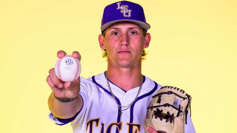 An LSU Tigers baseball player poses for a Portal Profile at Dawson Park, holding a glove and ball against a yellow background.