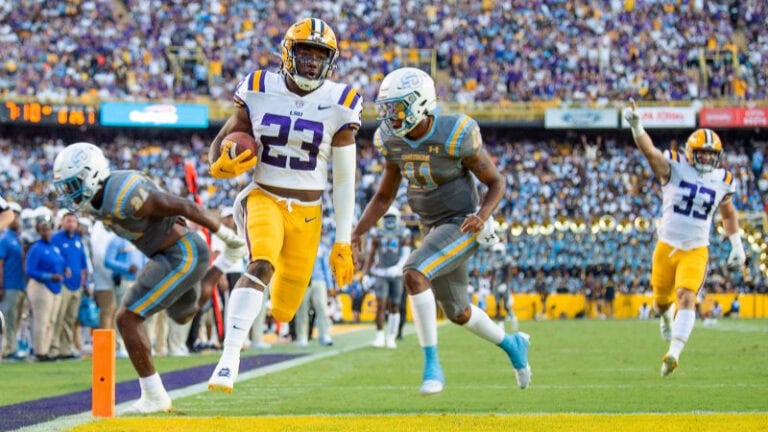 LSU player #23 runs into the end zone for a touchdown, energizing fans about upcoming in-state matchups and future games.
