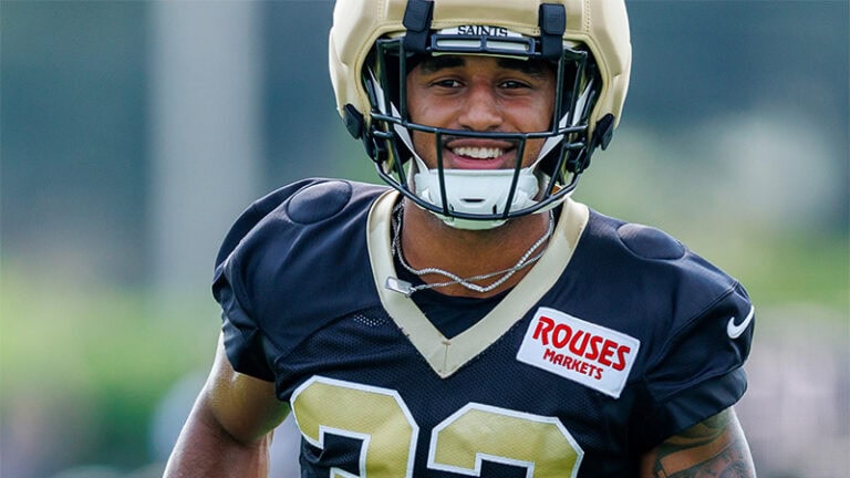 Jonas Sanker smiles during training camp, wearing a jersey with a “Rouses Markets” patch.