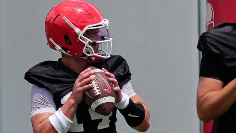 Gunner Stockton and black jersey readies to throw a football during fall camp practice.