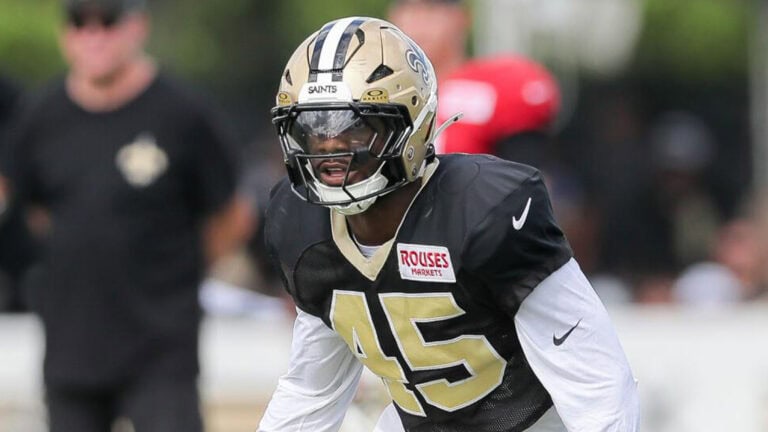 Deion Jones, in full Saints gear with helmet and visor, practices on the field wearing number 45.