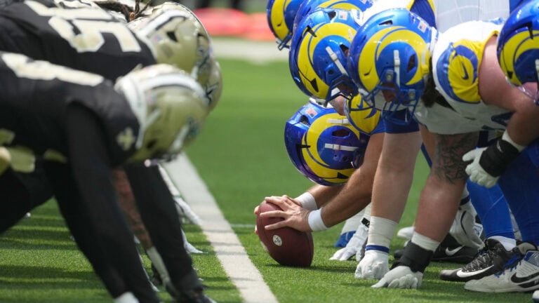 Two football teams line up, with the Saints focused on discipline as play starts amid recent penalty concerns.