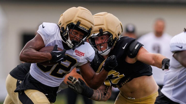 Two football players collide during Saints Training Camp on day 10, reflecting the team’s continuing challenges on offense.