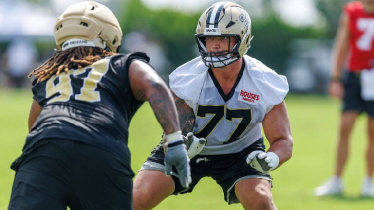 Dillon Radunz, back from a torn ACL, faces another Saints player during a practice drill on the football field.