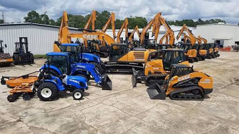 Construction equipment parked outside an industrial building on a Louisiana job site, prepared for efficient operation.