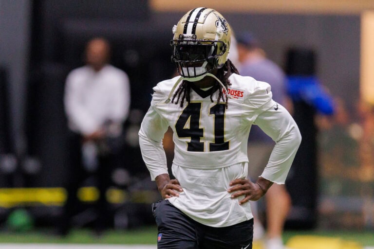 Alvin Kamara, in his number 41 jersey, stands with hands on hips during a Saints indoor practice session.