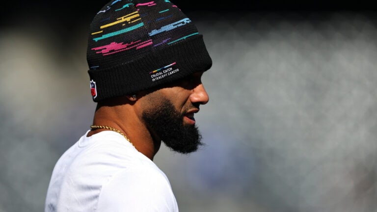 Chris Olave wears a black knit beanie featuring colorful horizontal dashes and the words “Crucial Catch Intercept Cancer.”
